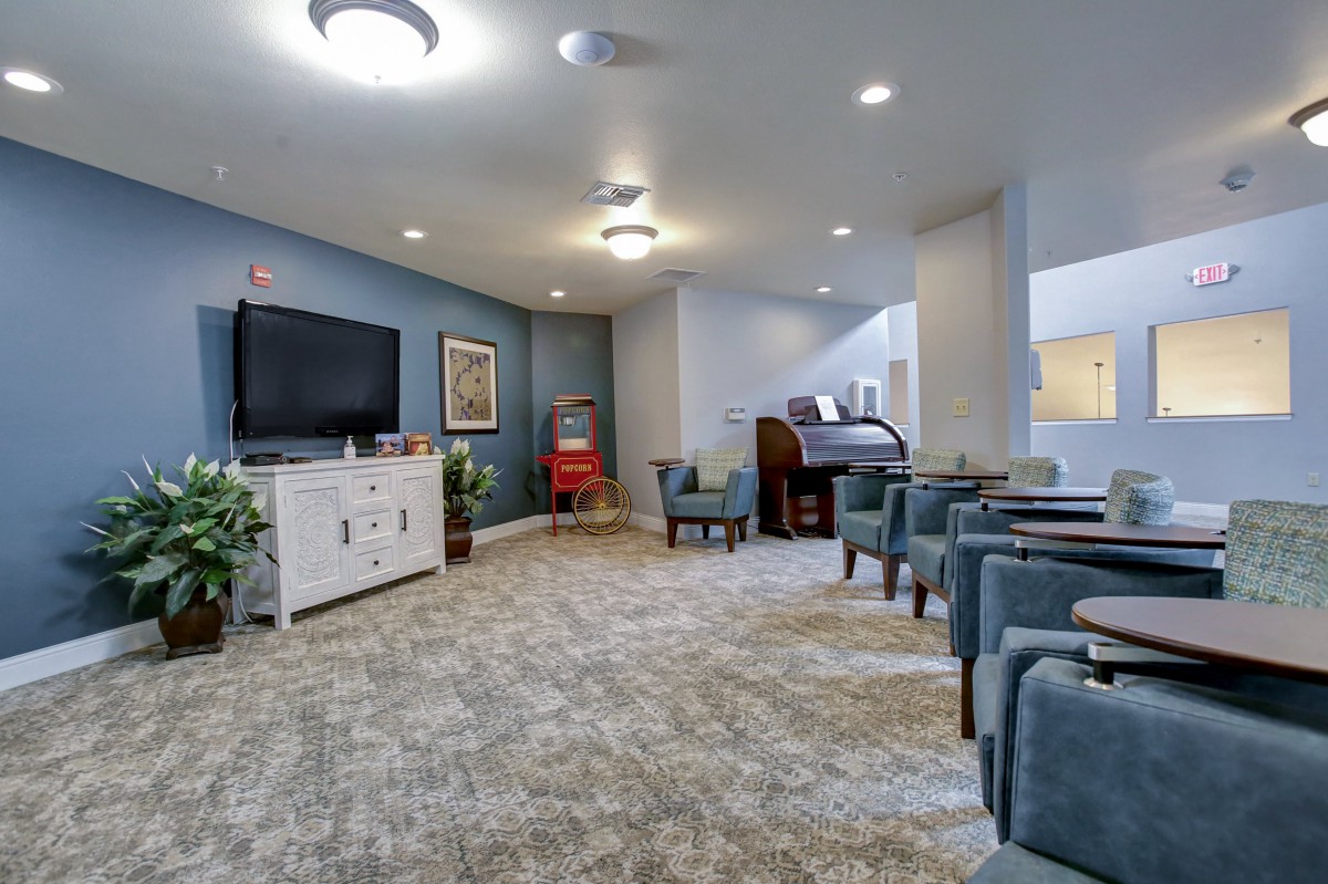 A modern living room with comfortable seating and a large television.