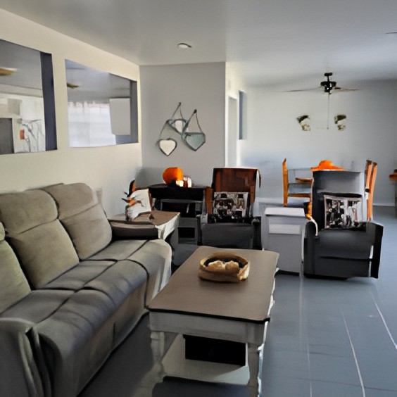 A modern living room with comfortable seating and a stylish dining area in the background.
