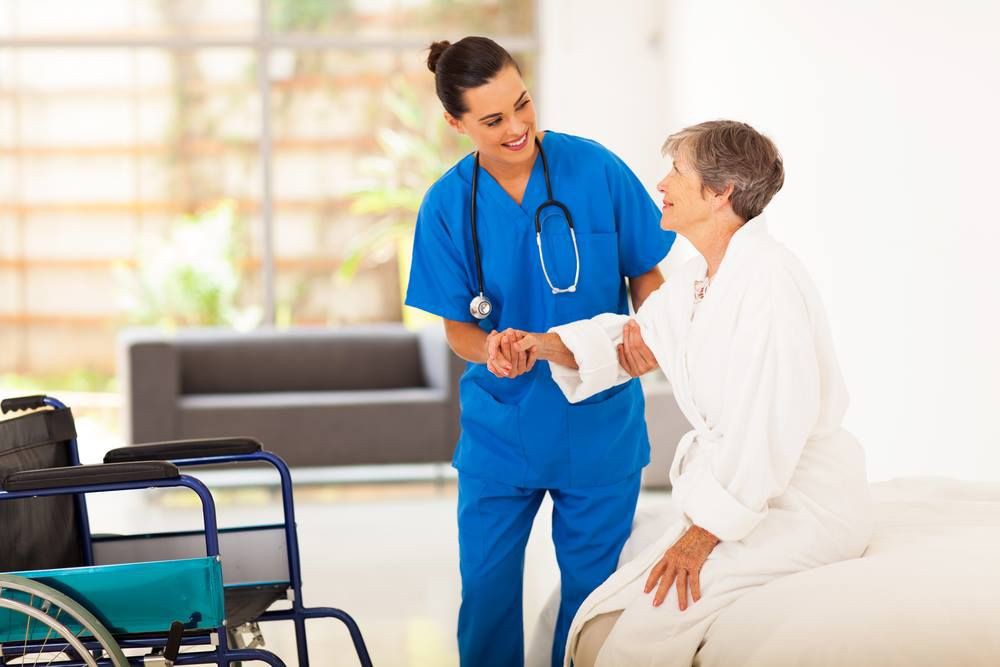 A nurse assisting an elderly patient in a healthcare setting.