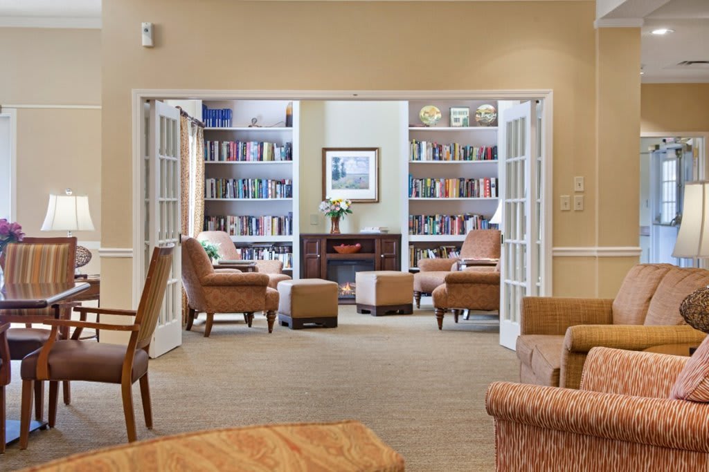 A cozy reading area with bookshelves and armchairs.