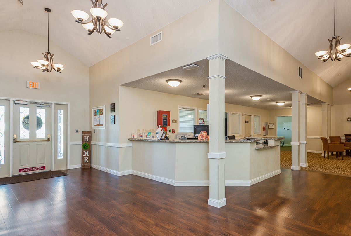An open-concept kitchen with a spacious layout, featuring hardwood flooring and elegant lighting.