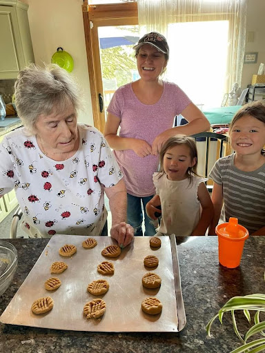 A delightful family baking session where grandparents and grandchildren share sweet moments while making cookies.