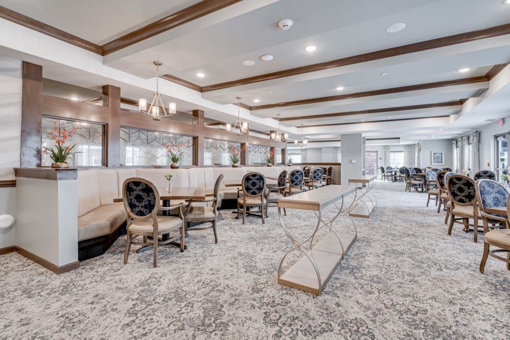 A modern and elegant restaurant interior featuring stylish seating and chandeliers.