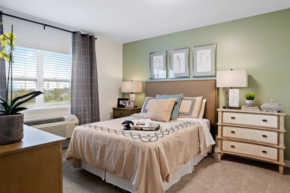A modern and cozy bedroom with a king-sized bed, two nightstands, and decorative lamps.