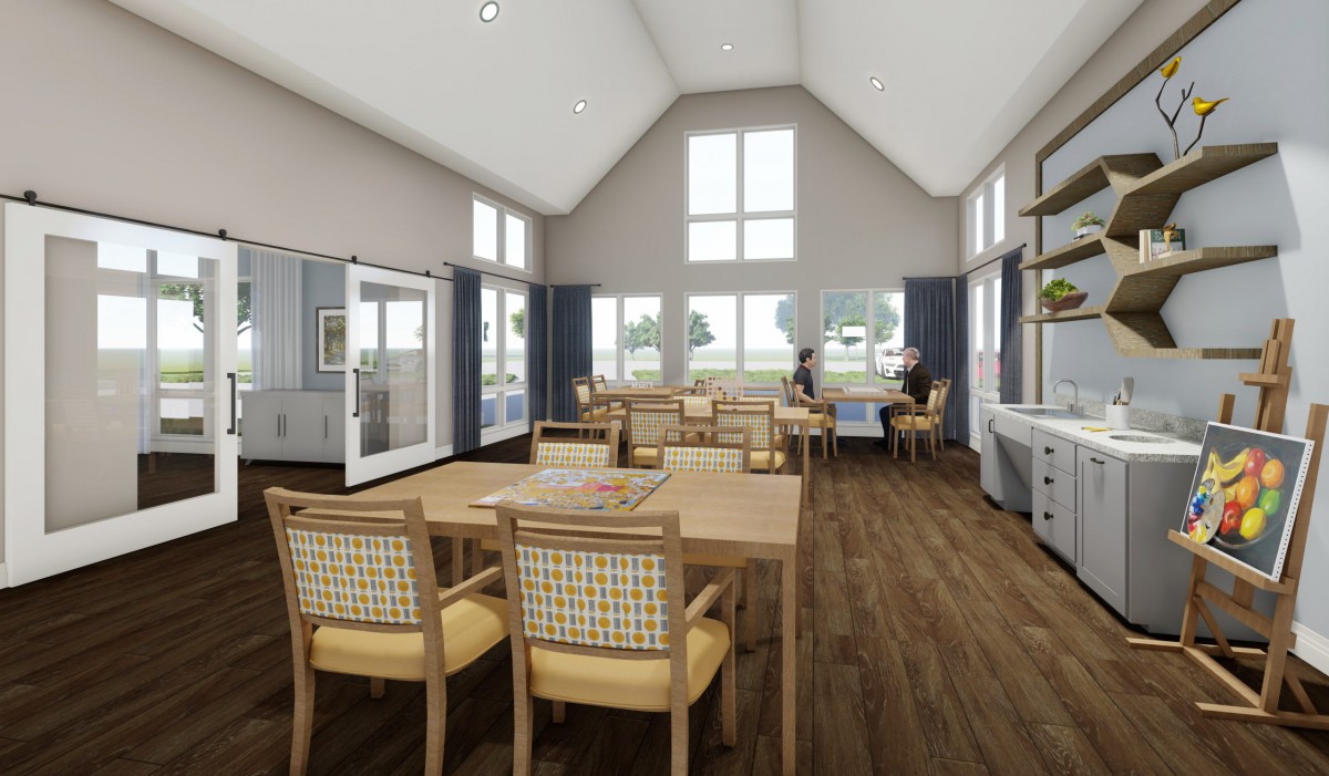 A modern dining area with wooden floors and large windows.