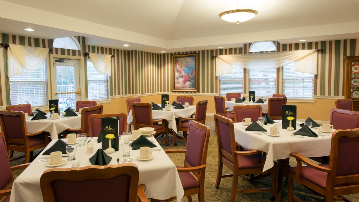 An elegant dining room with neatly arranged tables and chairs.