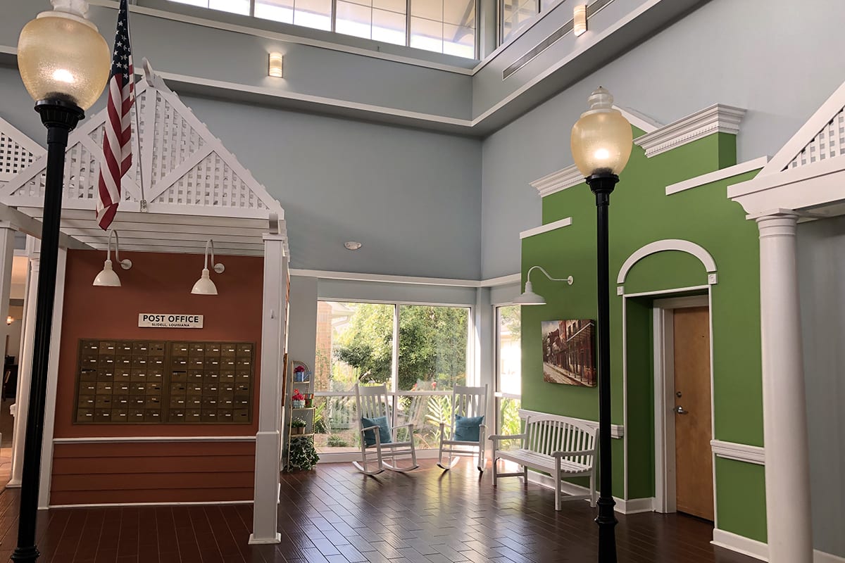 A well-lit lobby with mailboxes and a cozy seating area.