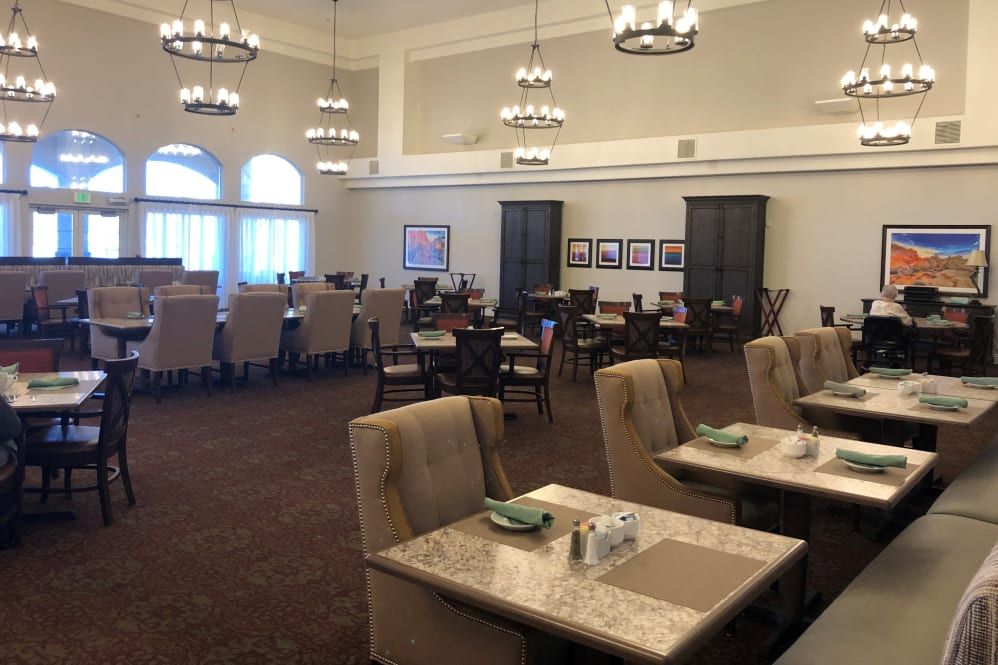 An elegant dining room with neatly arranged tables and comfortable seating.