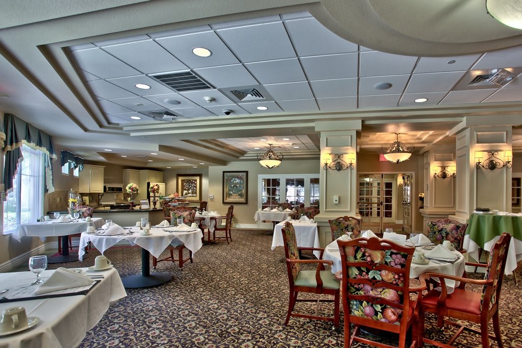 An elegant restaurant dining area with set tables and comfortable seating.