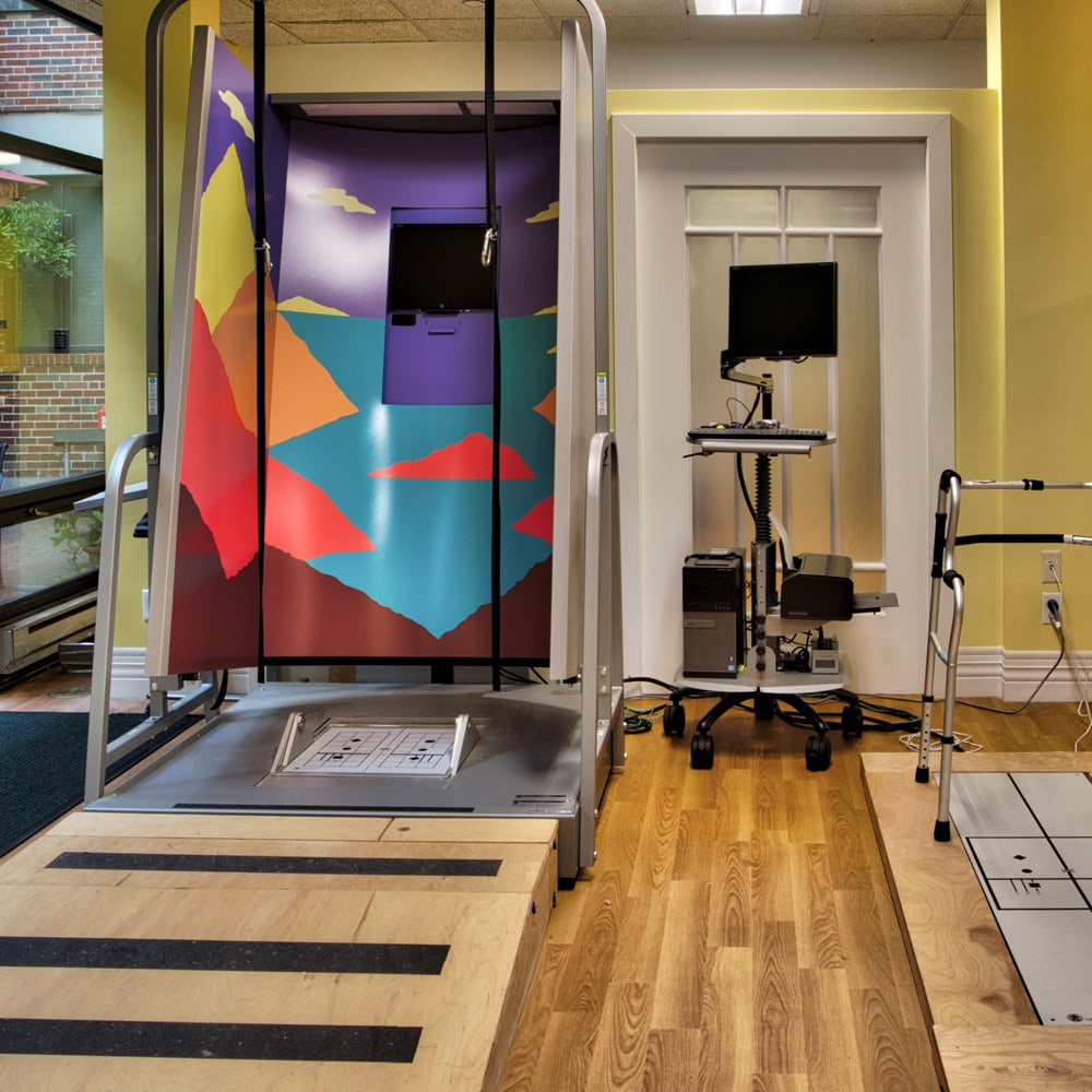 A modern rehabilitation and physical therapy room equipped with exercise technology.