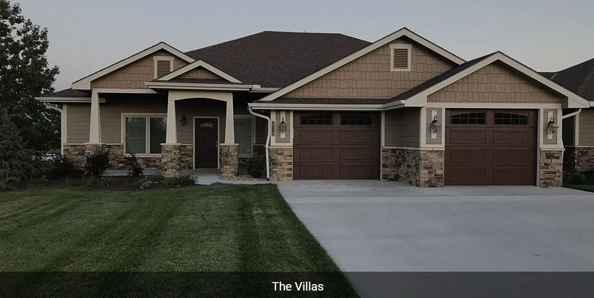 A suburban residential house with a driveway and garage.