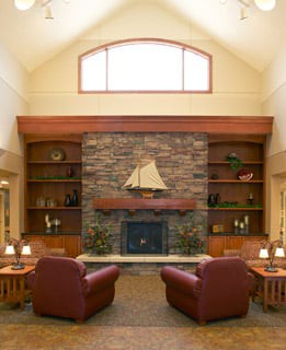 Cozy living room with a stone fireplace and comfortable armchairs.