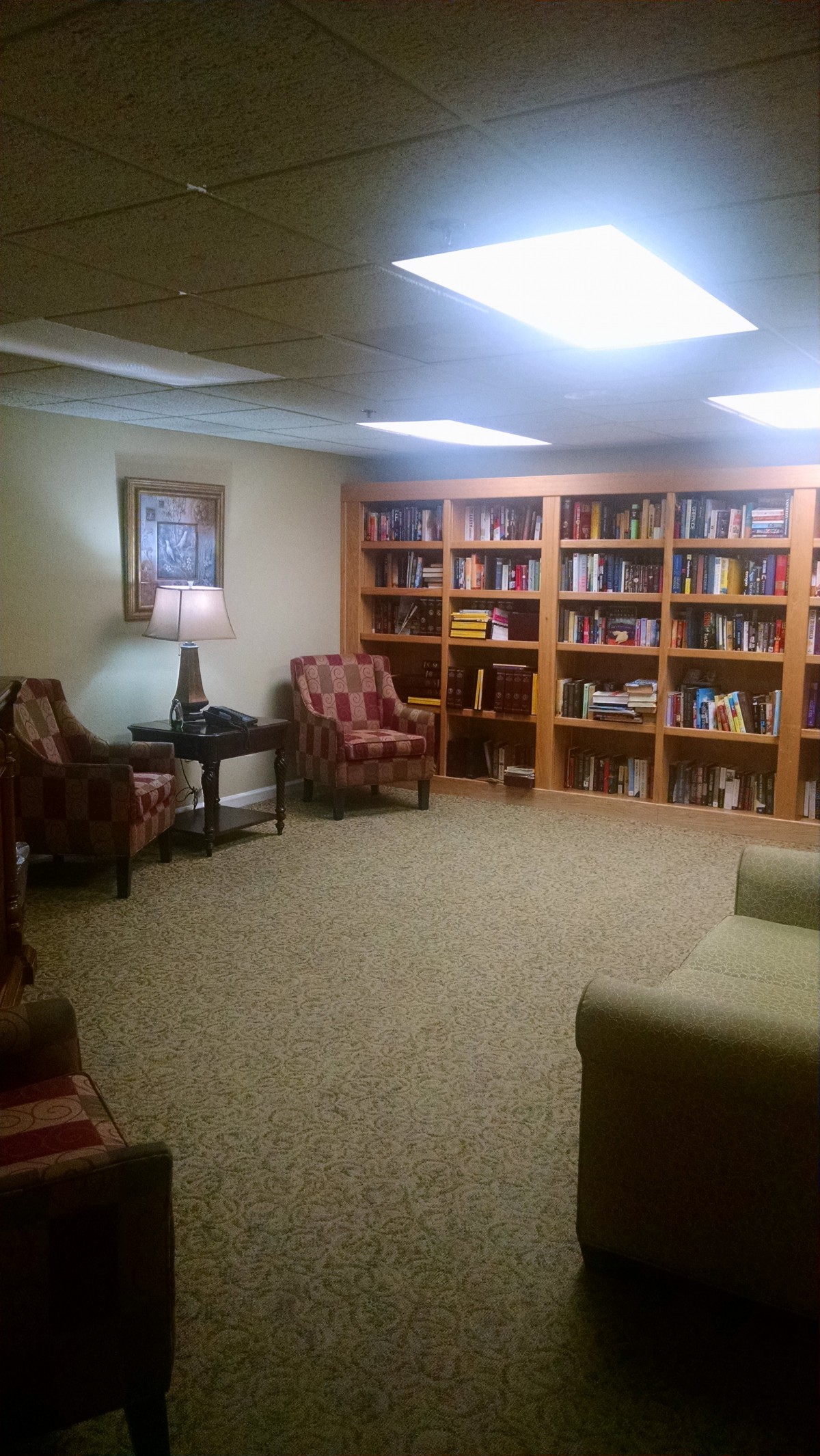 A cozy reading room with bookshelves and comfortable seating.