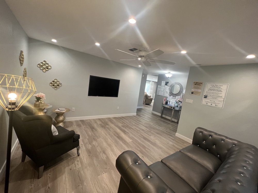 A modern living room with grey walls, wood flooring, and minimalist decor.
