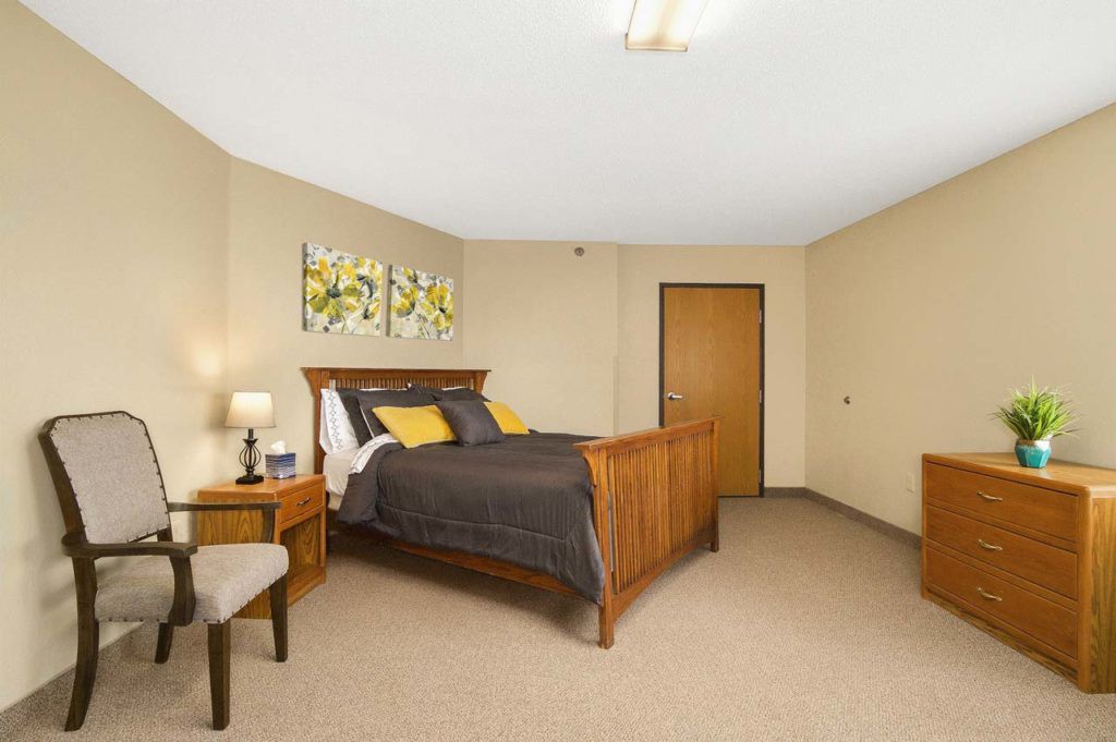 A cozy bedroom with a wooden bed, nightstands, and minimalist decor.