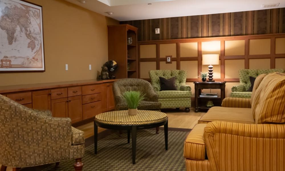 A cozy living room featuring comfortable seating and warm lighting.