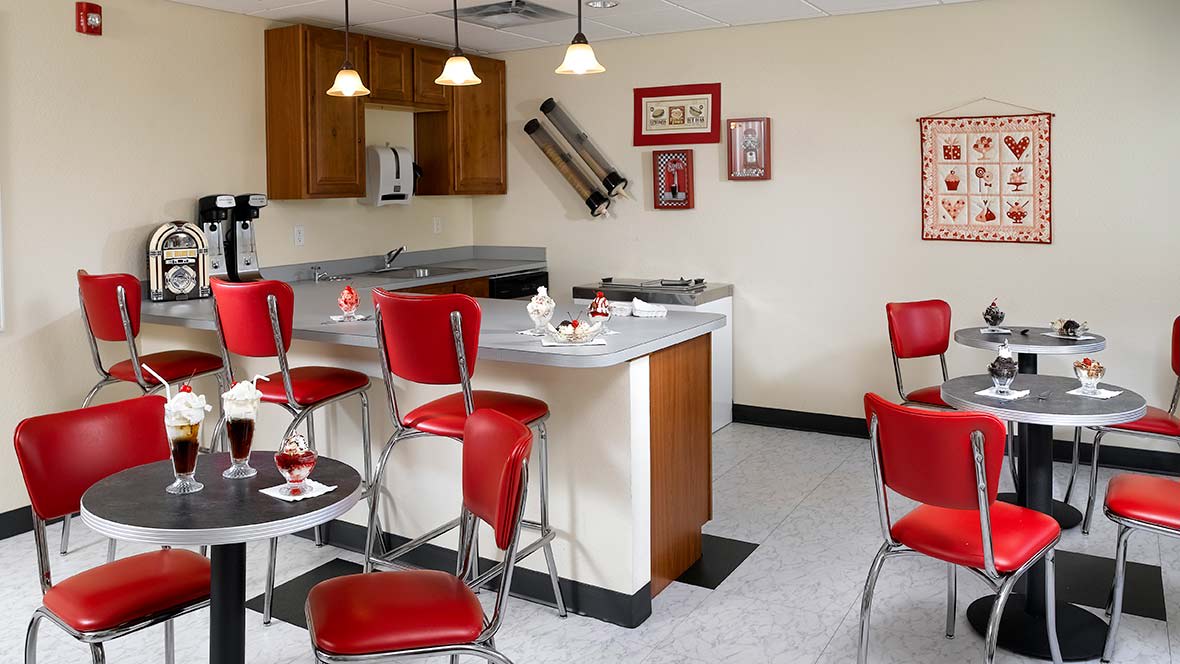 A retro-style kitchen with red diner chairs and vintage decor.