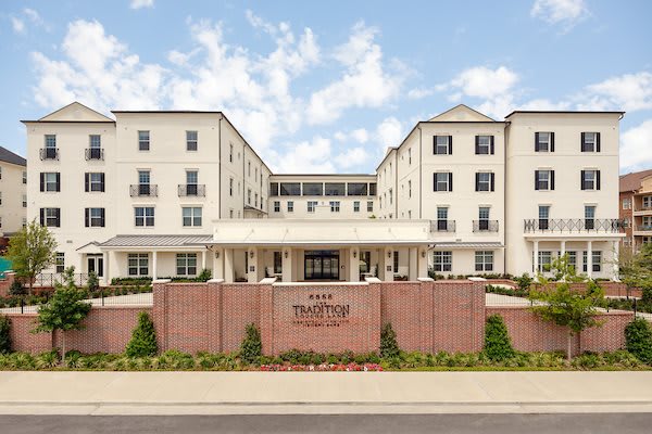 Front view of a multi-story hotel building with a landscaped entrance.