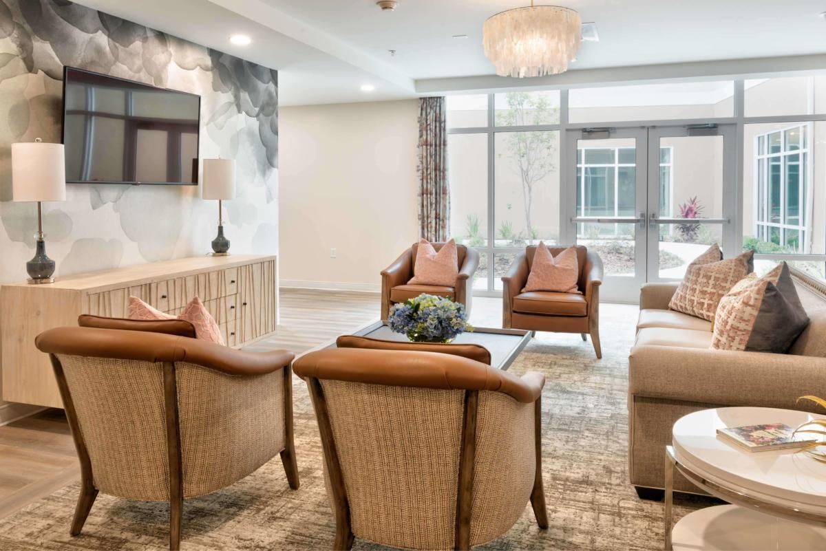A modern living room with stylish seating and natural lighting.