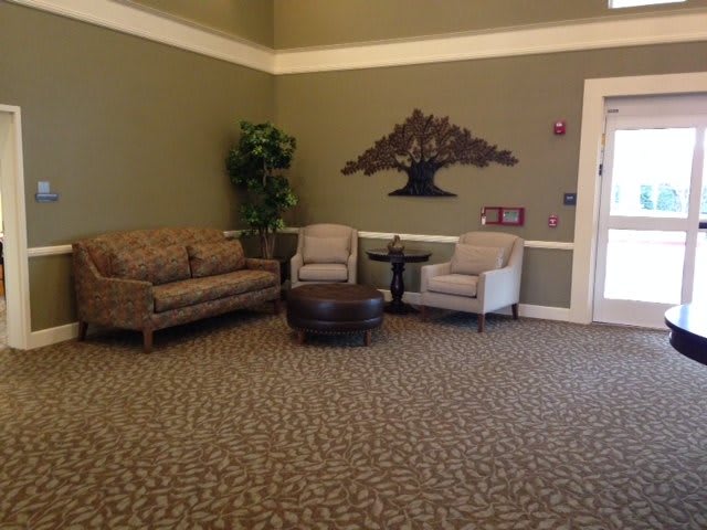 A cozy lobby area with seating and wall decor.