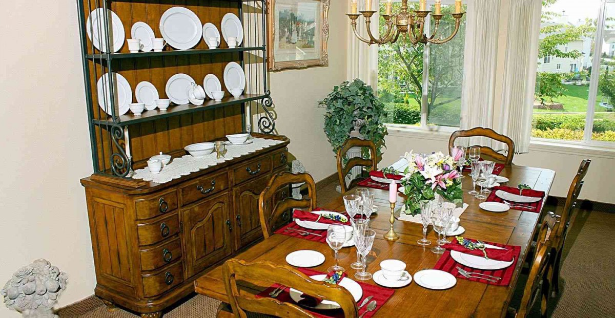 A classic dining room with a set table and elegant decor.