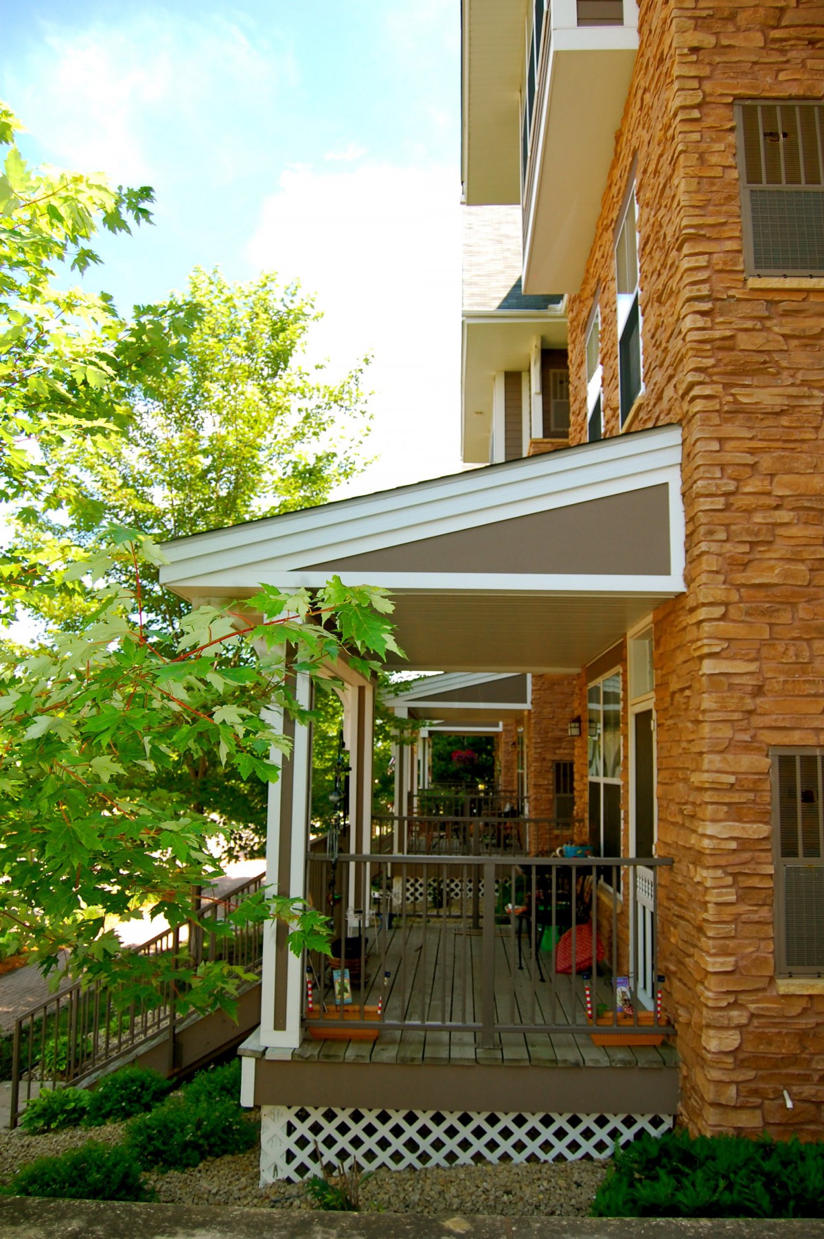 A building with brick exterior and balconies featuring awnings.