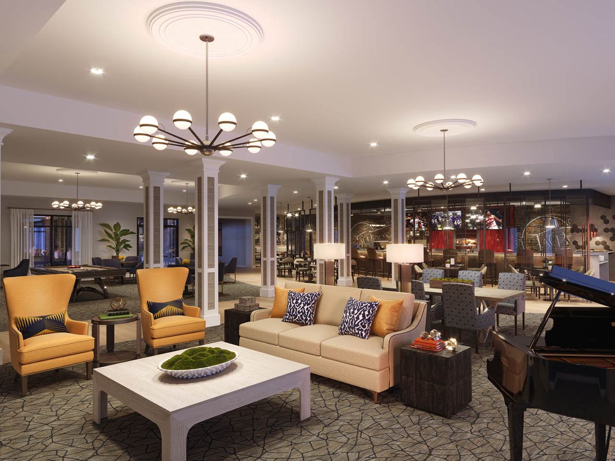 A spacious and elegantly furnished living room with modern lighting and comfortable seating.