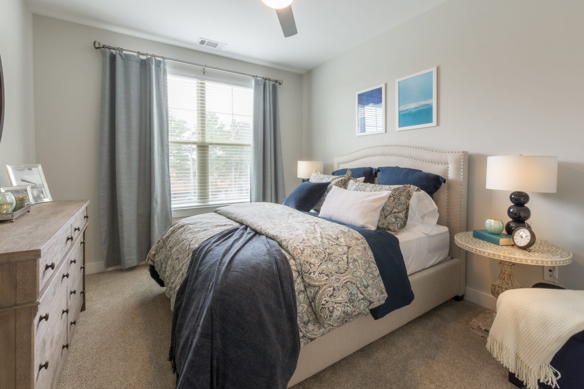 A cozy bedroom with stylish decor and natural light.