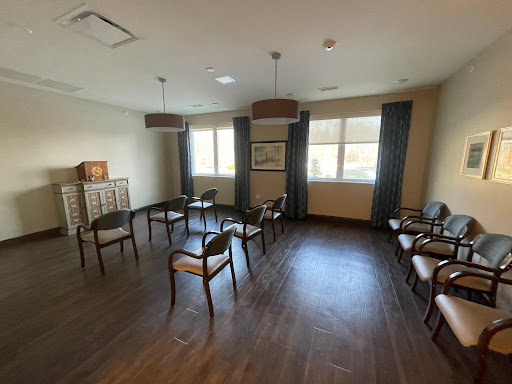 A serene waiting room with comfortable chairs and ample natural light.