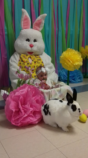 A delightful Easter scene featuring a baby surrounded by festive decorations and a friendly Easter bunny.