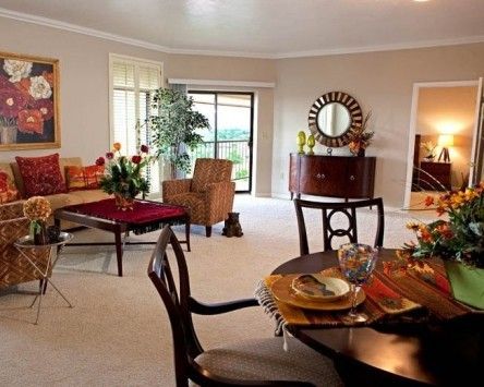 A cozy and elegantly furnished living and dining area with a stylish arrangement of furniture and decor.