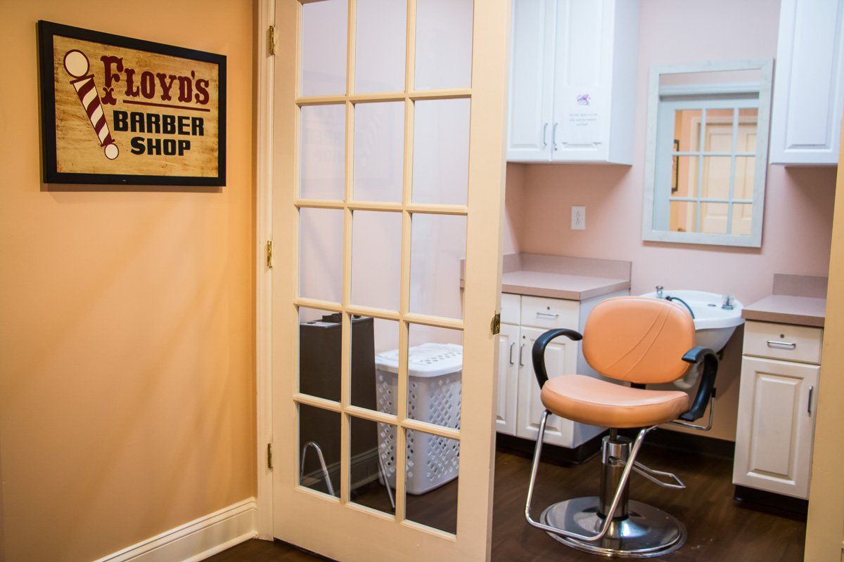 A cozy barber shop interior featuring a vintage chair and a welcoming atmosphere.