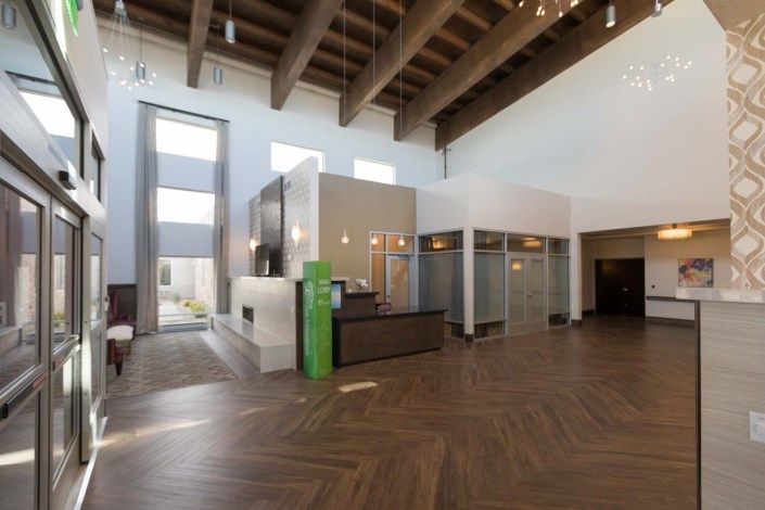 Modern lobby with high ceilings and a reception desk.