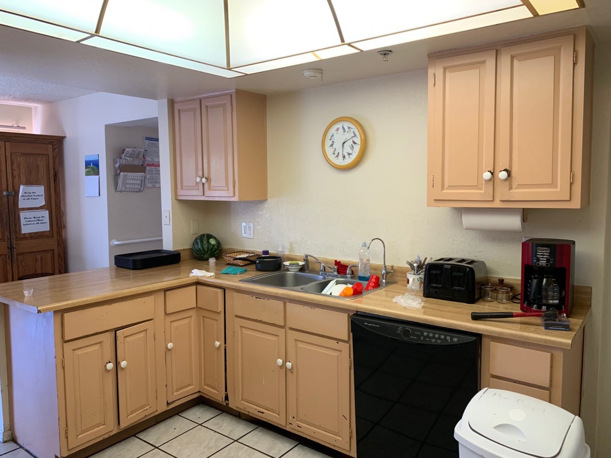A well-organized kitchen with wooden cabinets and various appliances.
