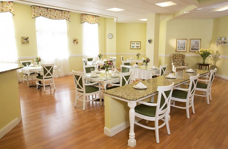 A bright and inviting dining room with neatly arranged tables and chairs.