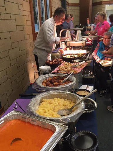 A vibrant buffet setup with a variety of dishes served at a community event.