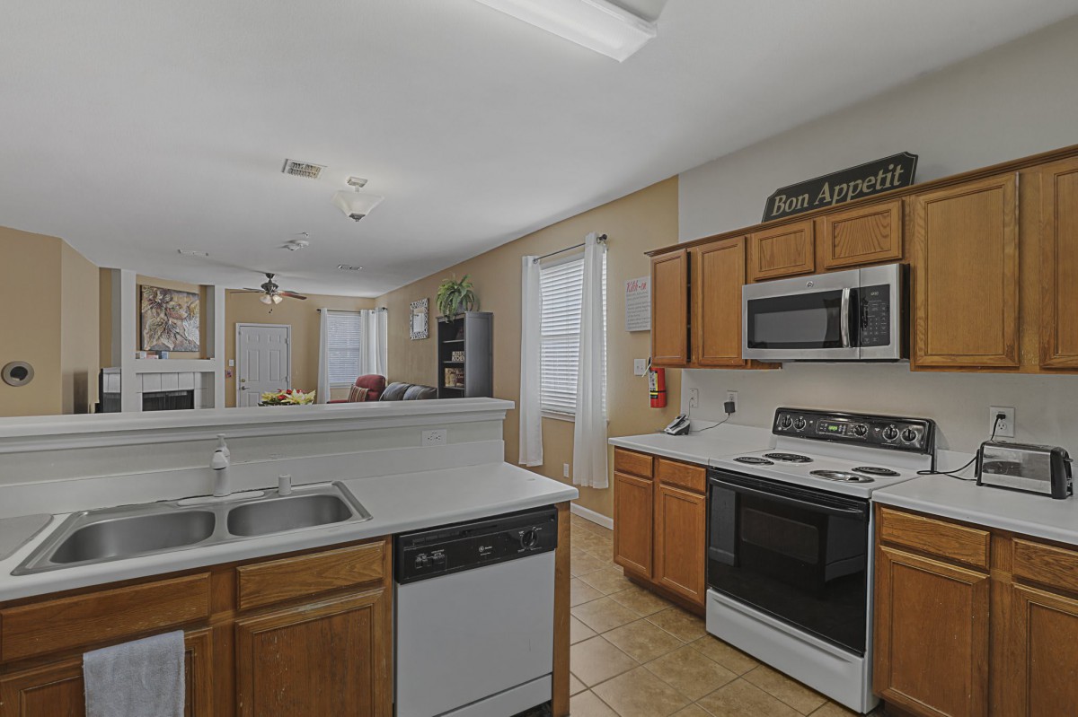 A modern kitchen with wooden cabinets and stainless steel appliances.