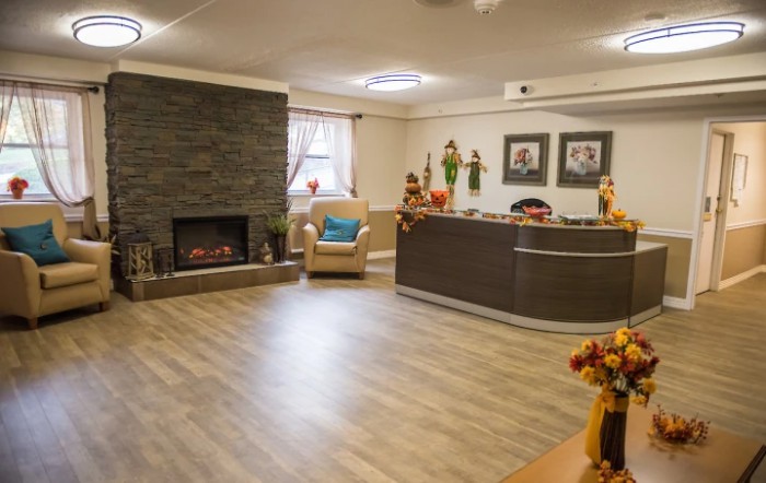 A cozy lobby with a fireplace and reception desk.