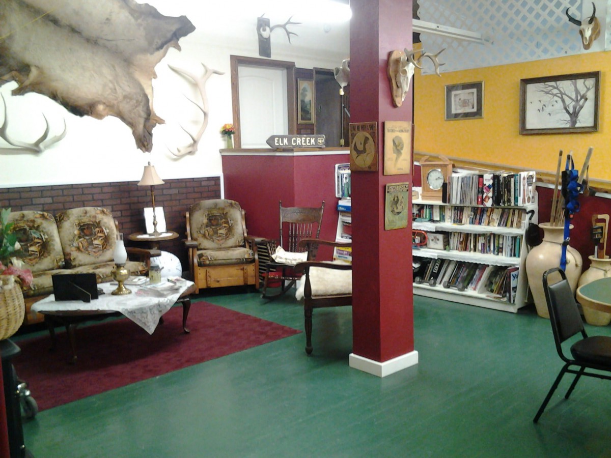 A cozy reading nook with bookshelves and comfortable seating.