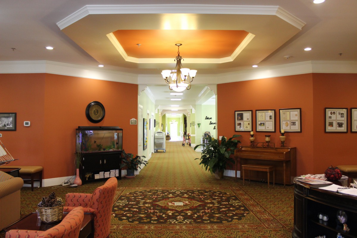 A warmly lit hallway with elegant furniture and decor.
