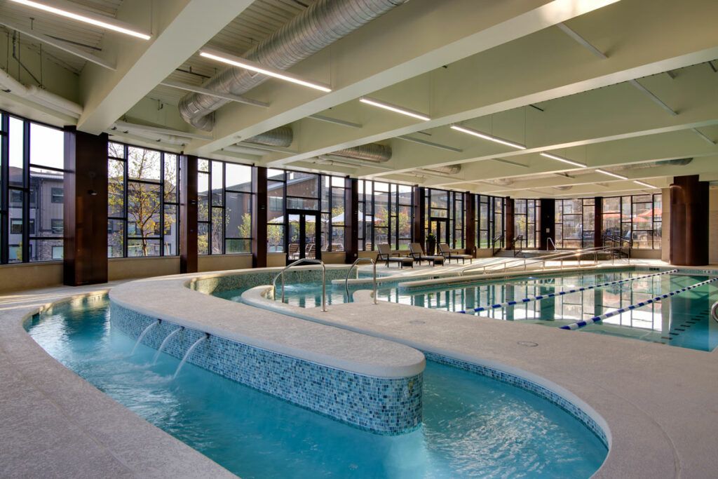 An indoor swimming pool with a water feature in a leisure facility.