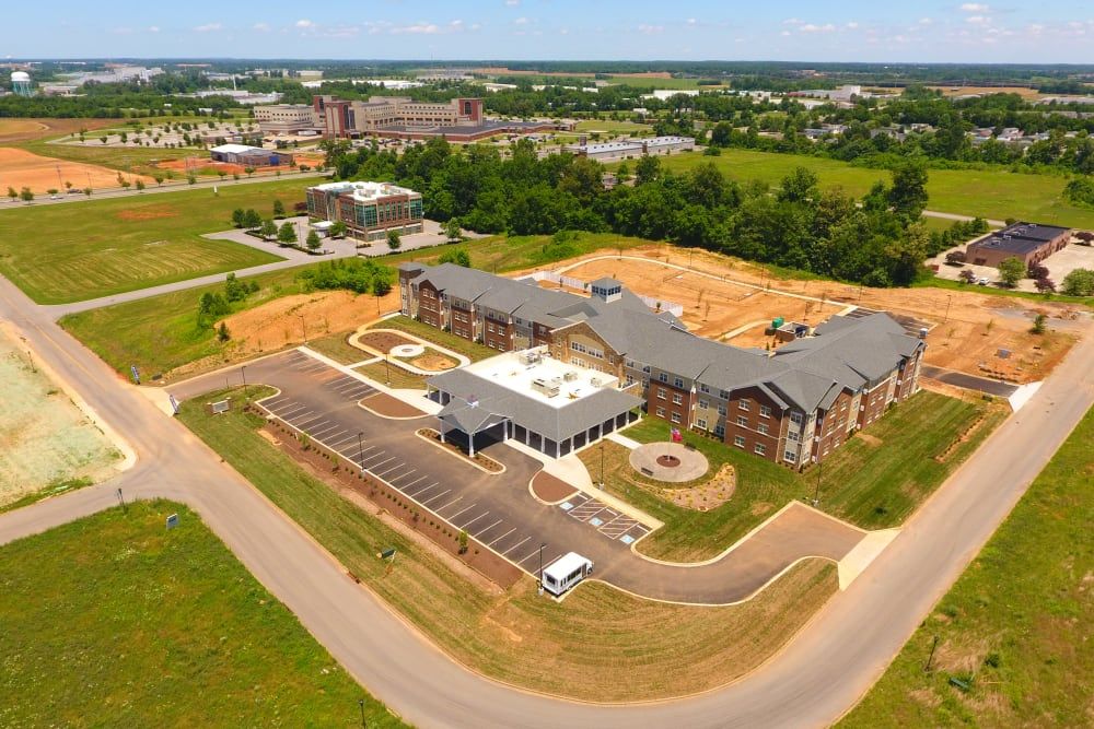 Aerial view of a suburban building complex with surrounding greenery.