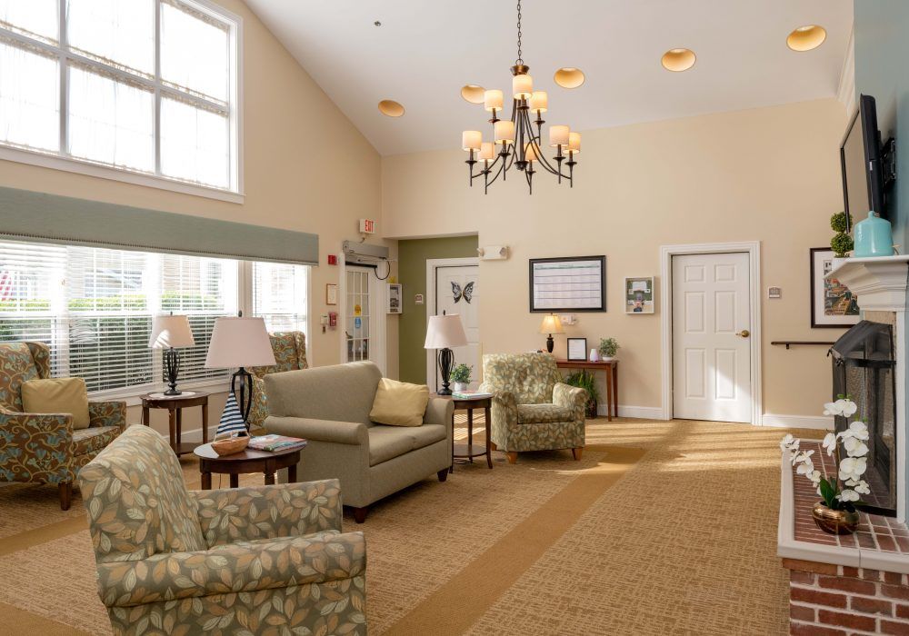 A cozy living room with comfortable seating and a chandelier.