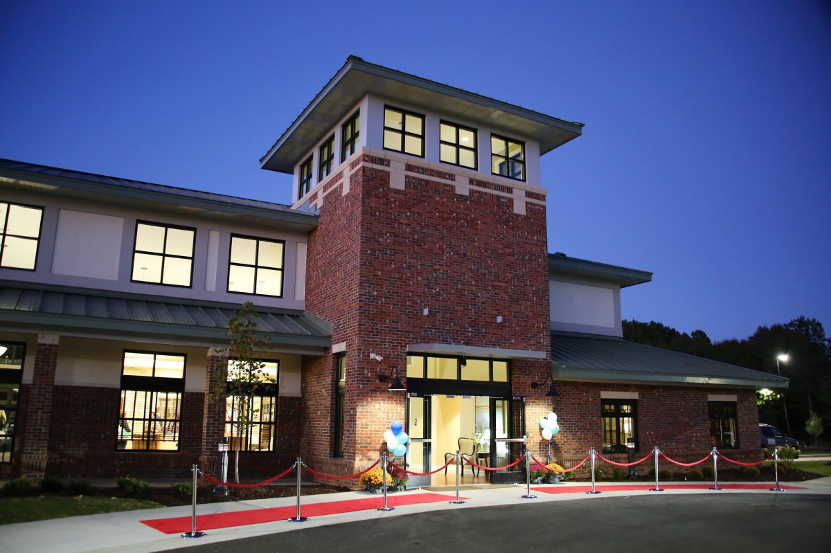 Brick building with illuminated windows in the evening.
