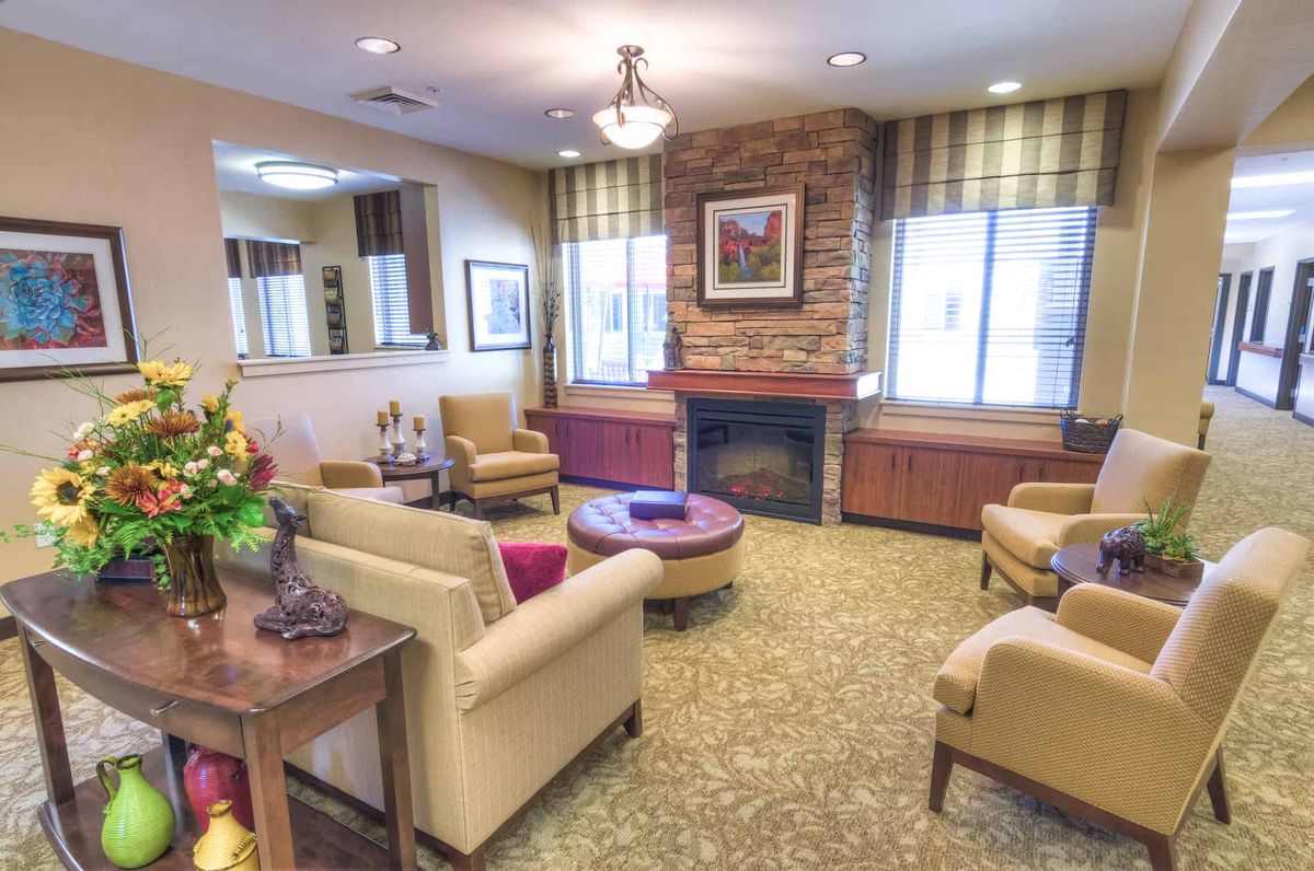 A cozy living room with comfortable armchairs and a fireplace.