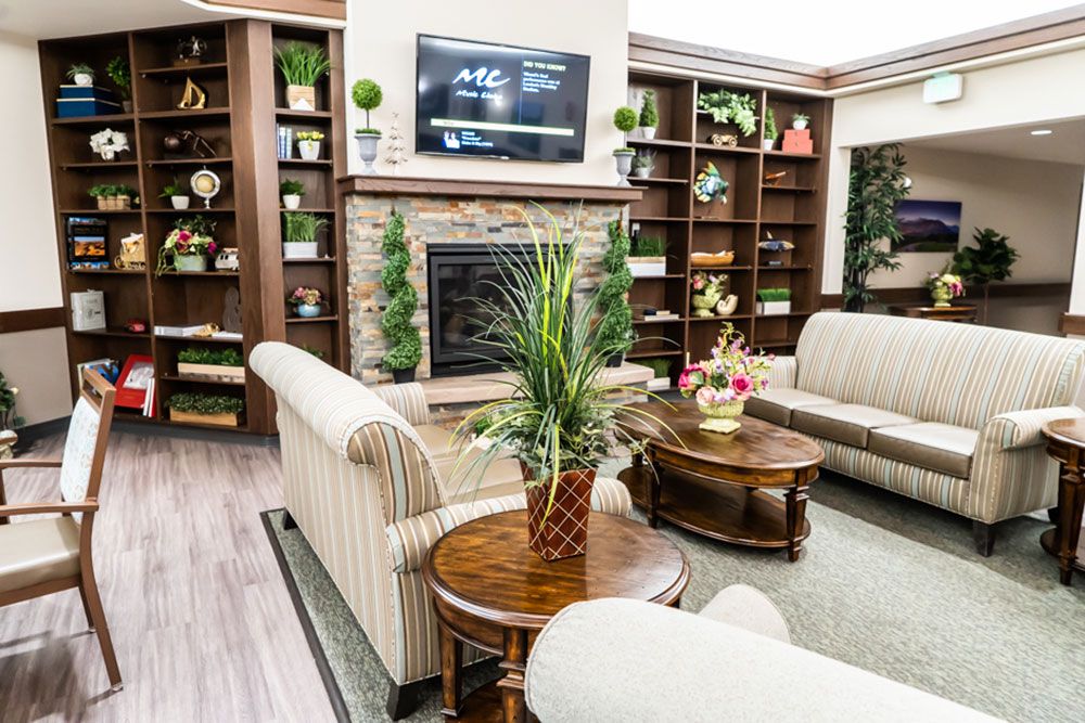 A cozy living room with elegant furniture and a warm fireplace.