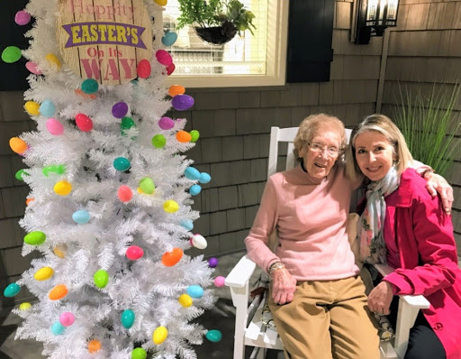 A joyful moment celebrating Easter with family, featuring a beautifully decorated white tree.