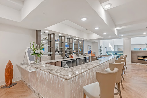 A stylish modern bar area with elegant seating and contemporary decor.