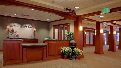 A welcoming reception area with wooden finishes and decorative plants.