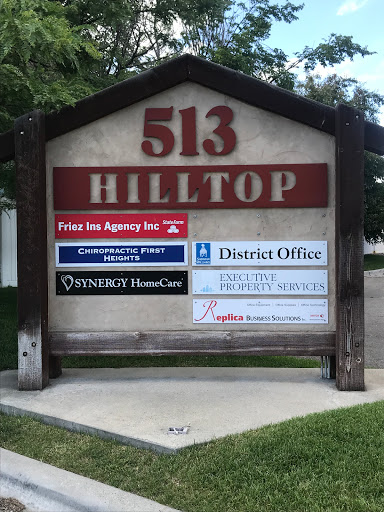 A sign displaying various businesses located at 513 Hilltop.
